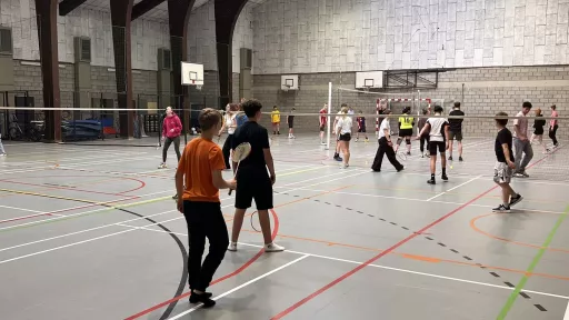 Élèves jouant au badminton dans le hall omnisports